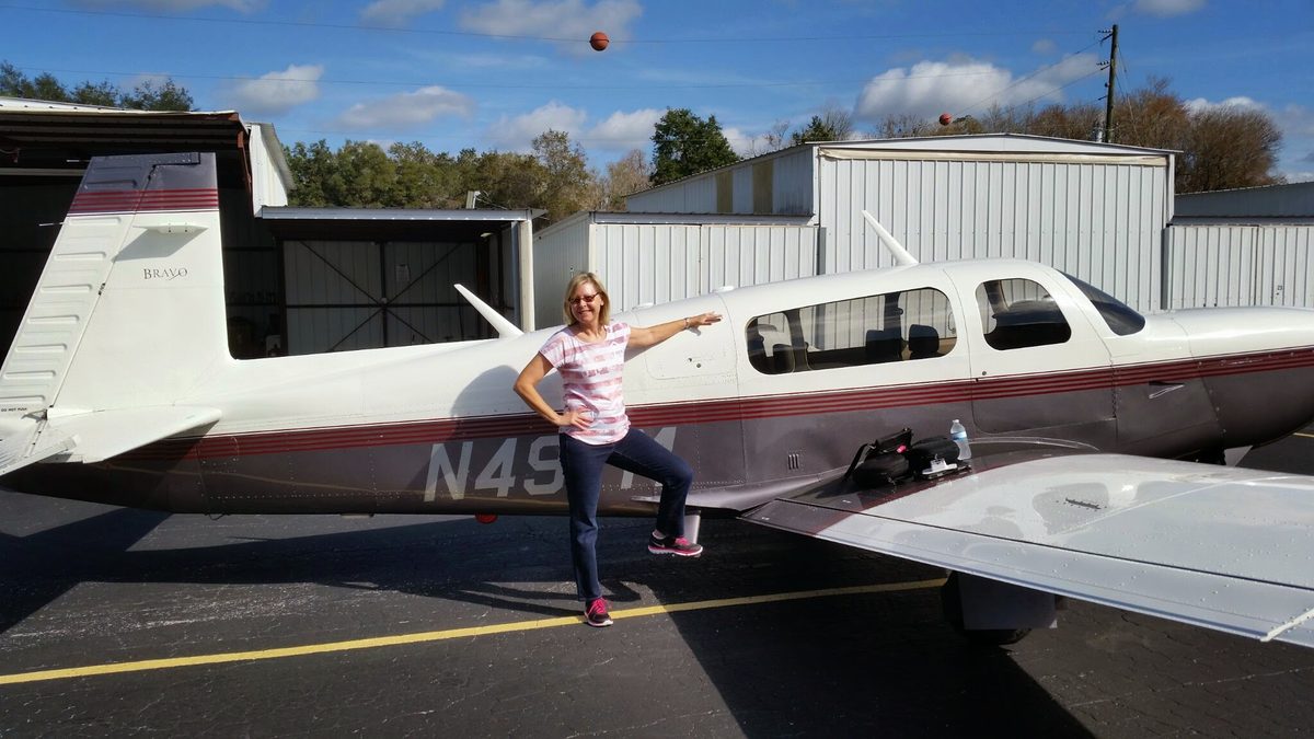 instructor and owner with a Mooney on the ramp
