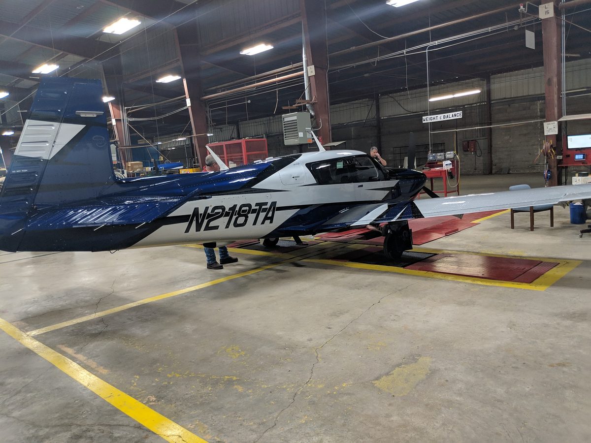 Mooney in the hangar with the cowling open
